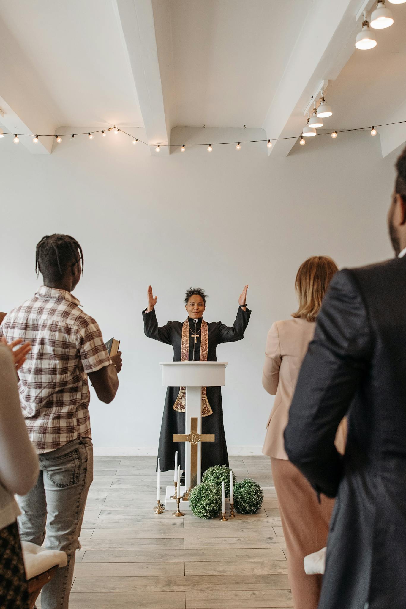 A multiracial congregation participates in an inspiring religious service led by a passionate preacher.